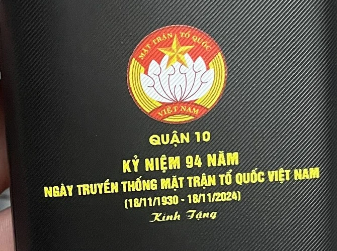 Góc cận logo và nội dung kỷ niệm màu vàng trên sạc dự phòng đen